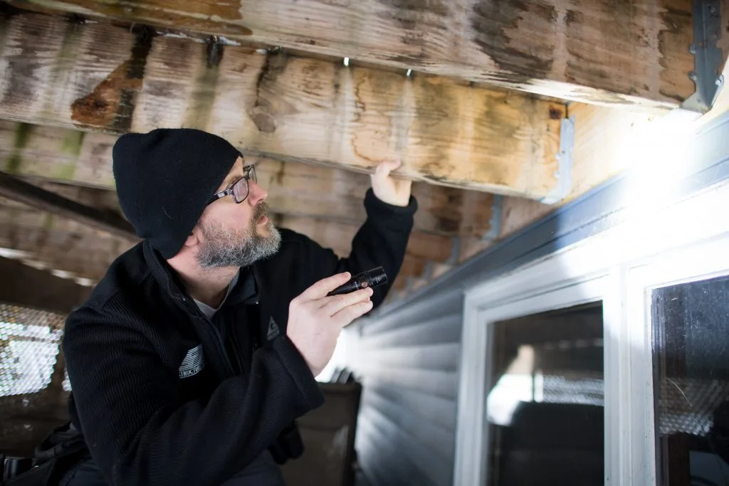 man-checking-underside-deck