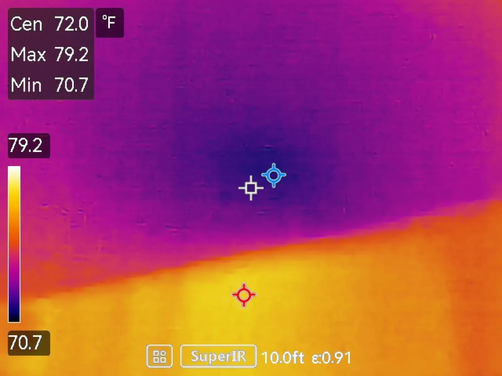 Thermal image of a ceiling showing a dark cool area above a warmer wall section